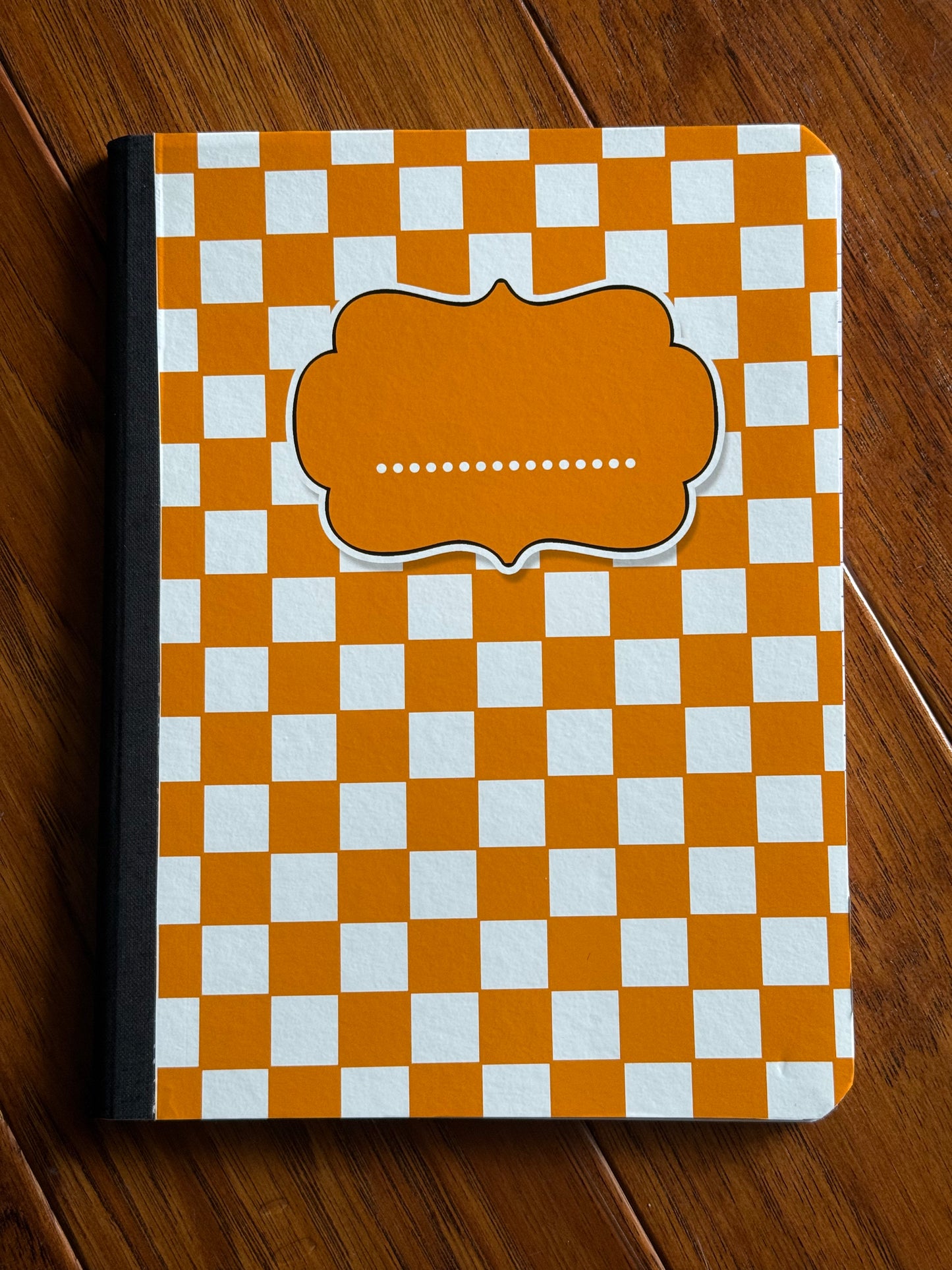 Orange/white checkered notebook-wide ruled
